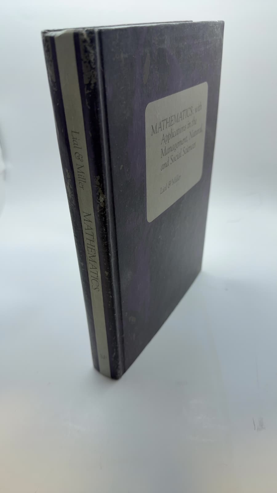 MATHEMATICS: with Applications in the Management, Natural, and Social Sciences by Margaret L. Lial & Charles D. Miller - quarter view showing binding condition